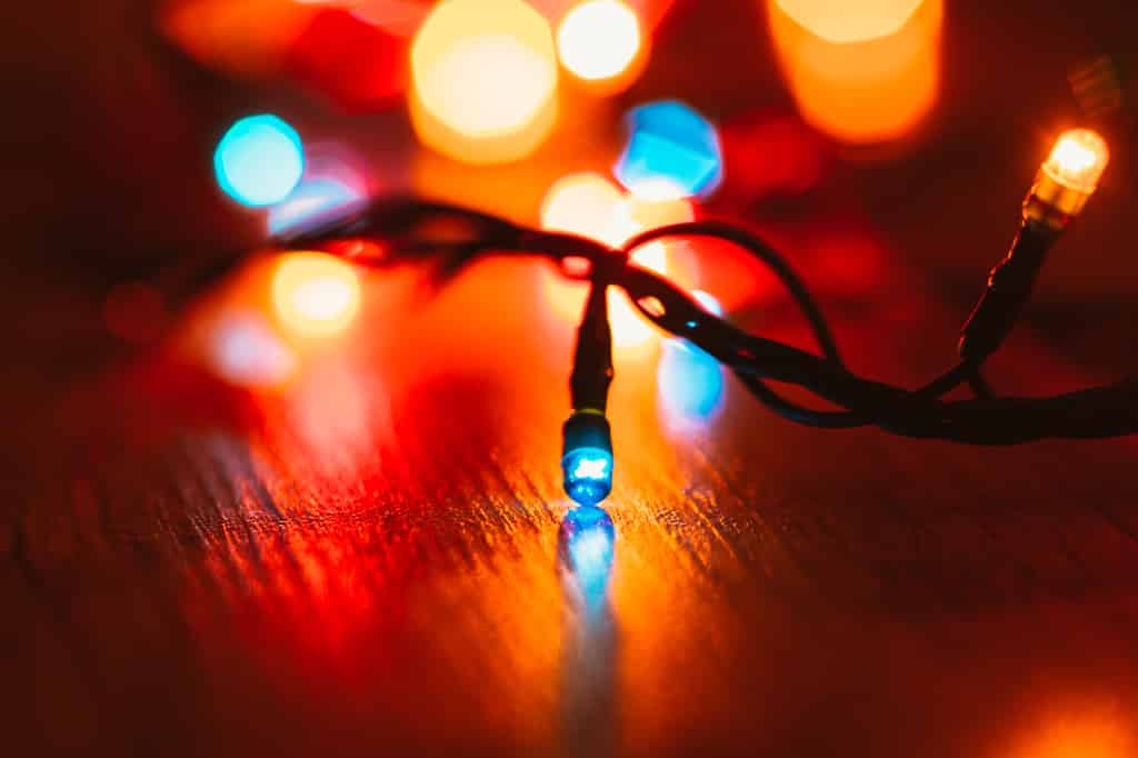 Christmas lights on wooden background. Selective focus