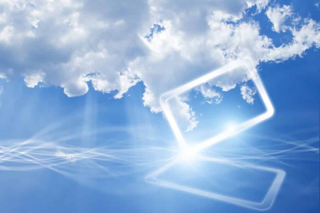 Technology background - concept of cloud computing. Abstract tablet PC in blue sky with white clouds.